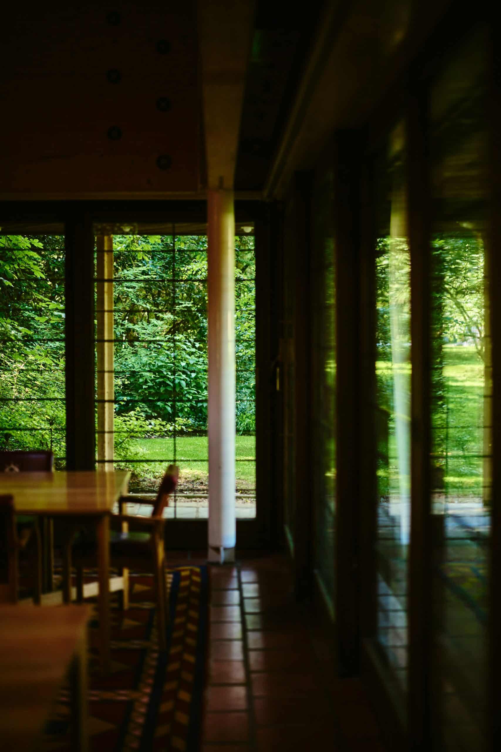 Interior of Linbury Building with view through windows of trees