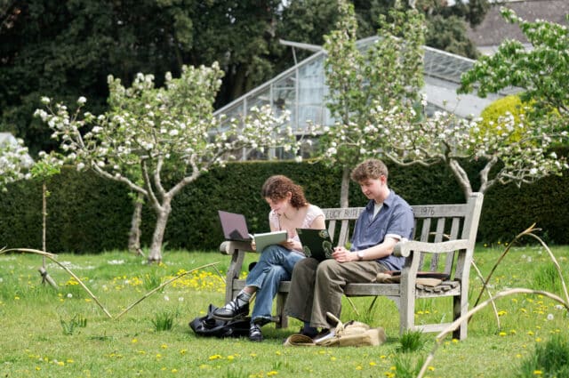 Students working on a bench in the Orchard